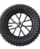 A black tire with deep treads mounted on a black wheel featuring a silver hubcap and multiple spokes. The tire has visible markings indicating size and specifications.